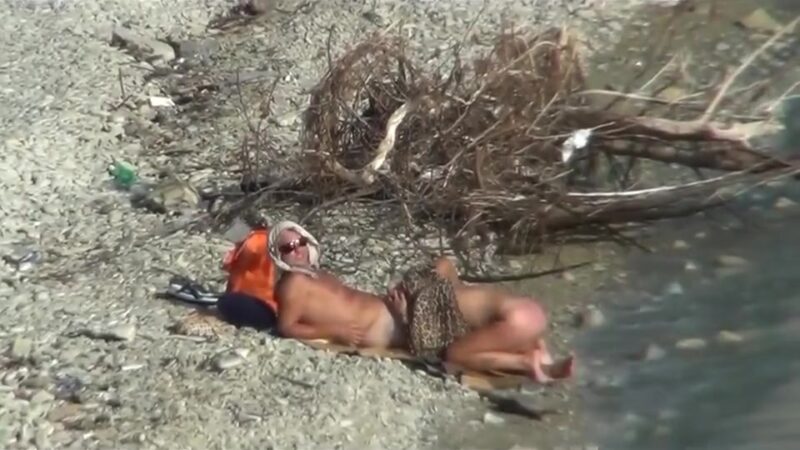 Couple fucking on a public beach, while walking past people
